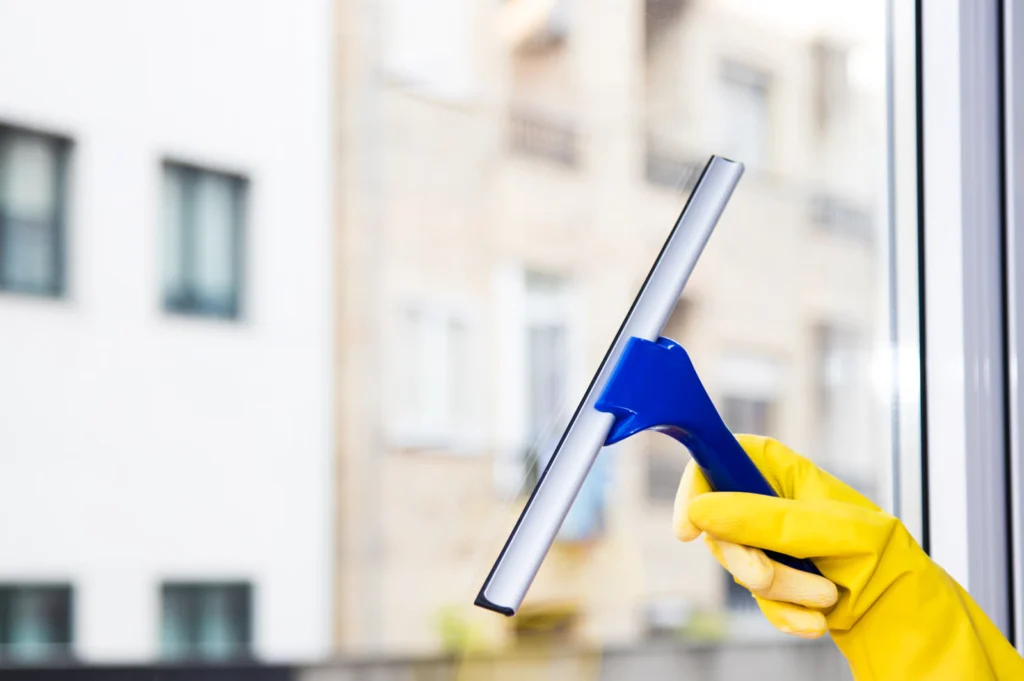 Residential window cleaner representing how to turn more window cleaning leads into booked jobs