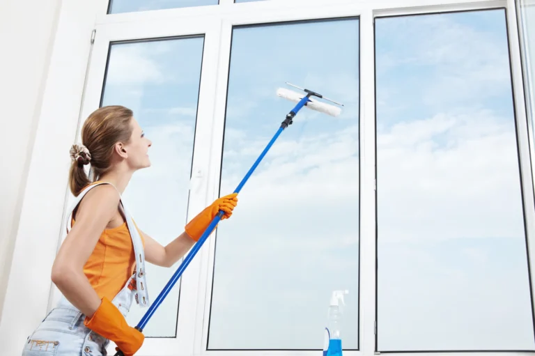 Window washing professional using window washing software to turn more quotes into booked jobs
