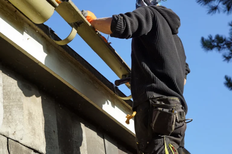 Professional gutter cleaning service removing debris from residential gutters